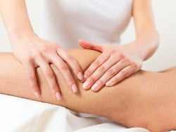 Massage therapist working on a tight calf