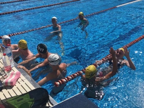 Swimmers giving high-five after training in Torremolinos